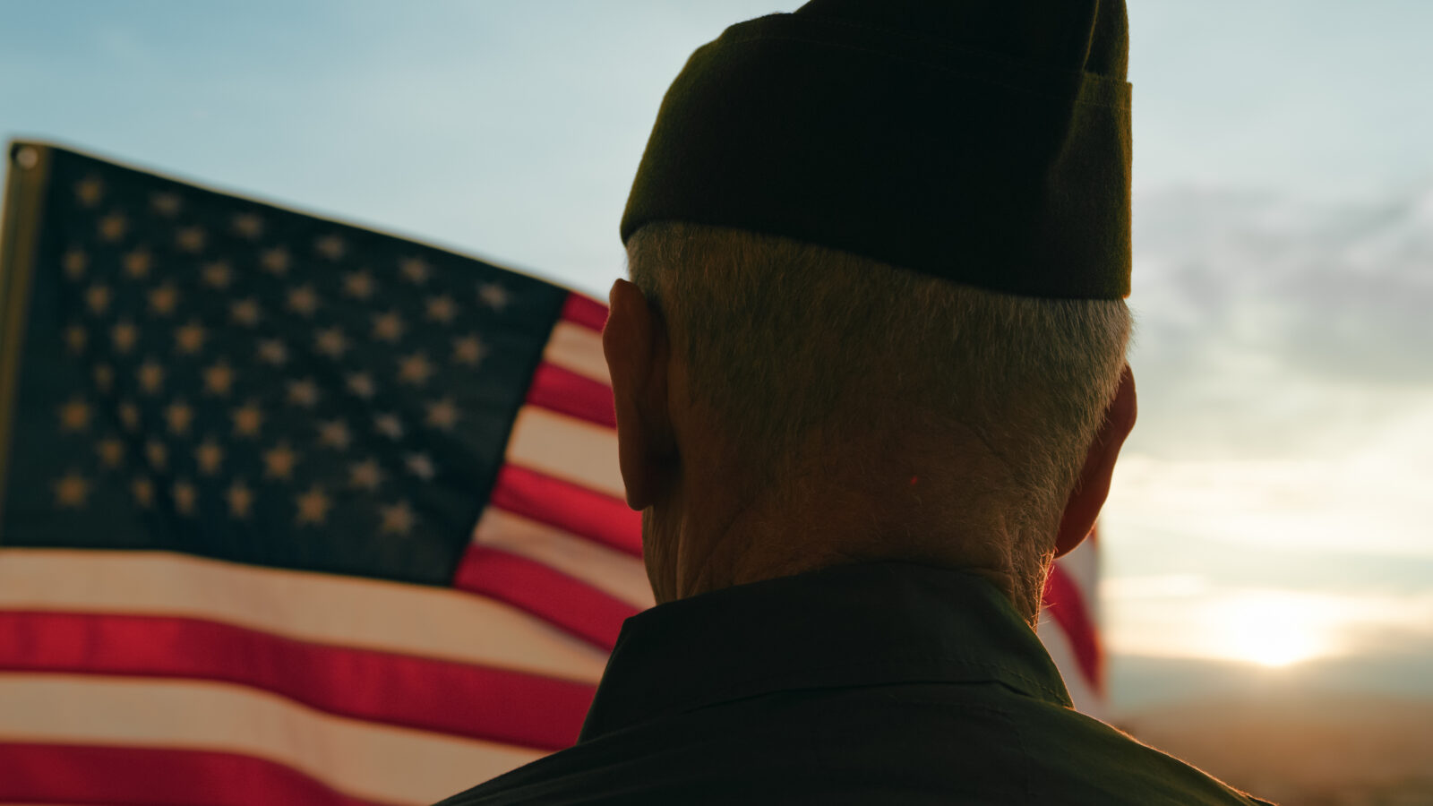 Elderly Man Stand Against American Flag For Veterans Day Holiday