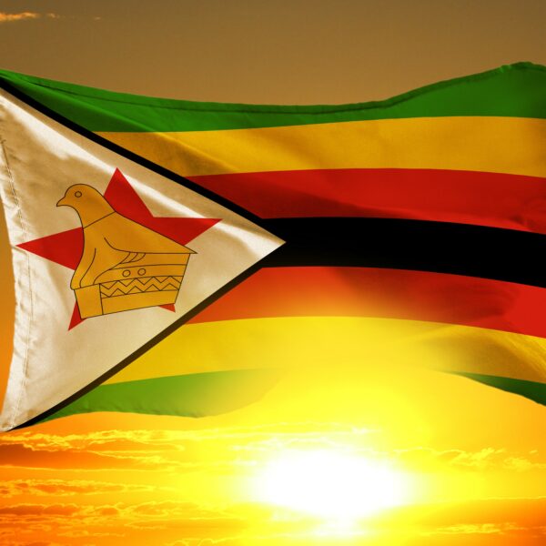 Zimbabwe flag against orange sunset